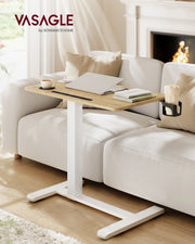 Overbed table across a sofa in a living room with a fireplace and books