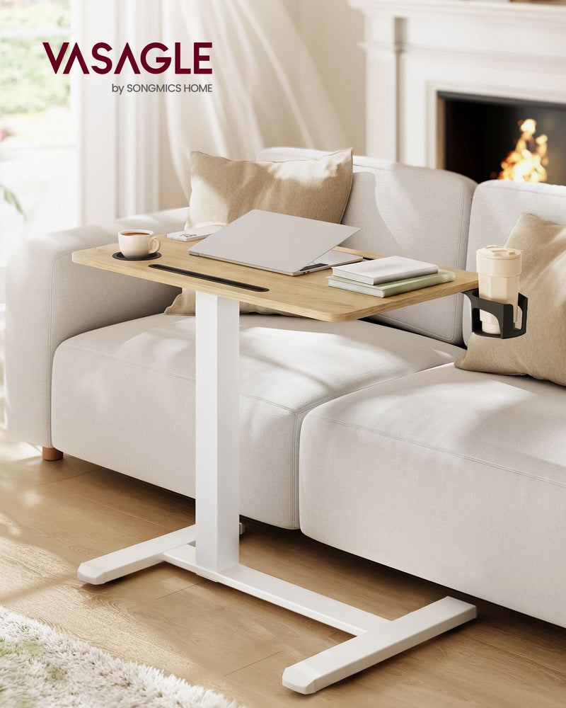 Overbed table across a sofa in a living room with a fireplace and books