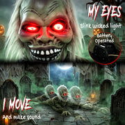 Close-up of the crawling zombie's glowing red eyes and bared teeth