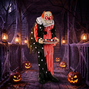 Animated candy tray clown decoration on a haunted porch with jack-o'-lanterns and lanterns