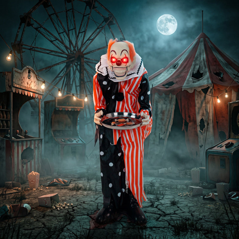 Candy tray clown decoration standing at a derelict fairground at night