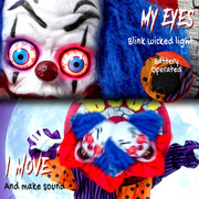 Close-up of the clown's glowing blue eyes and battery compartment with rotating head motion