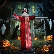 Animated Halloween clown decoration displayed in a haunted house yard scene with jack-o-lanterns and ghosts