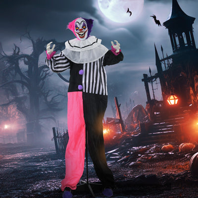 Animated Halloween clown decoration staged in a spooky graveyard scene with a full moon and bats