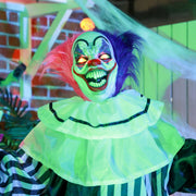 Close-up of the clown's glowing eyes and painted mask under coloured lighting
