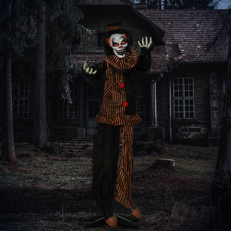 Striped clown decoration lit up at night outside a derelict house