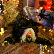 Animated Halloween crawling zombie decoration displayed on a decorated porch with pumpkins and candles