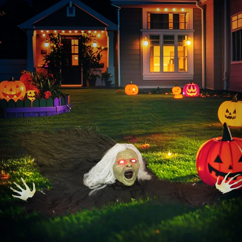 Outsunny Halloween crawling zombie decoration placed outdoors on a lawn at night among jack-o-lanterns