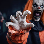 Close-up of the Joker clown's reaching hand with blurred face in the background
