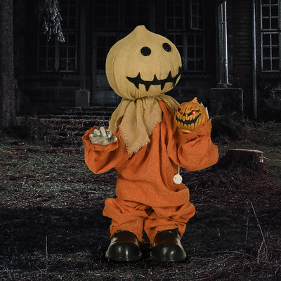 Sack head Halloween figure standing on bare soil outside a dark house at night