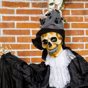 Close-up of the skull face, grey top hat and white lace cravat