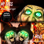 Close-up of the glowing green eyes and battery compartment with two witch heads shown moving