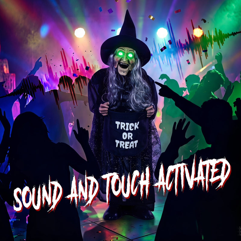 Animated witch decoration with glowing eyes at a colourful indoor Halloween party
