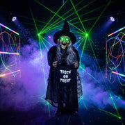 Animated witch decoration with glowing eyes staged among coloured laser lights