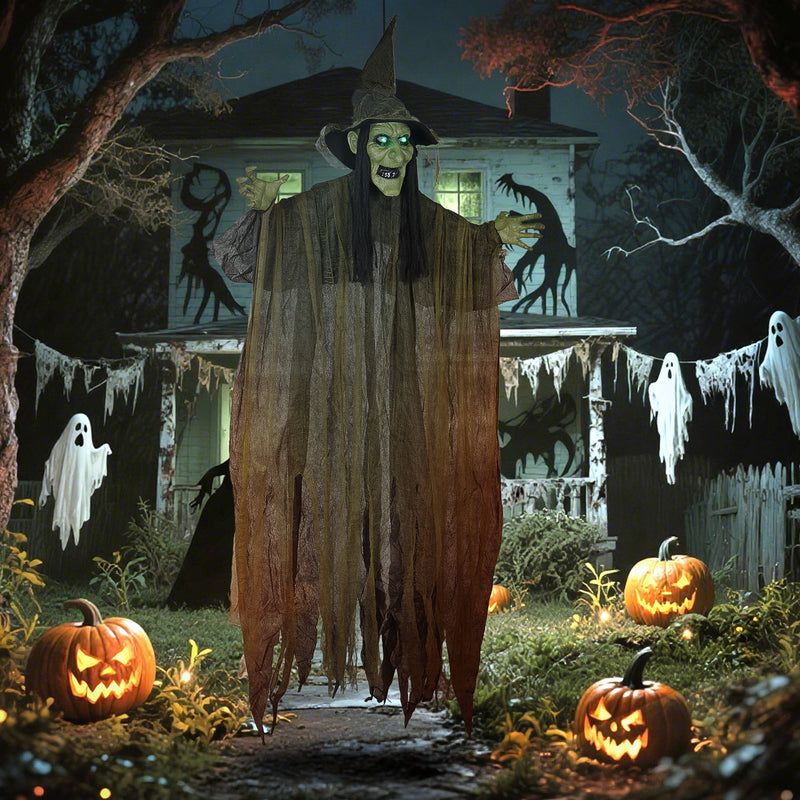 Outsunny hanging Halloween witch decoration lit up outside a house at night among pumpkins and ghost decor