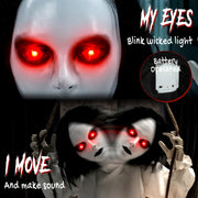 Close-up of the hanging swing ghost's glowing red eyes and battery pack