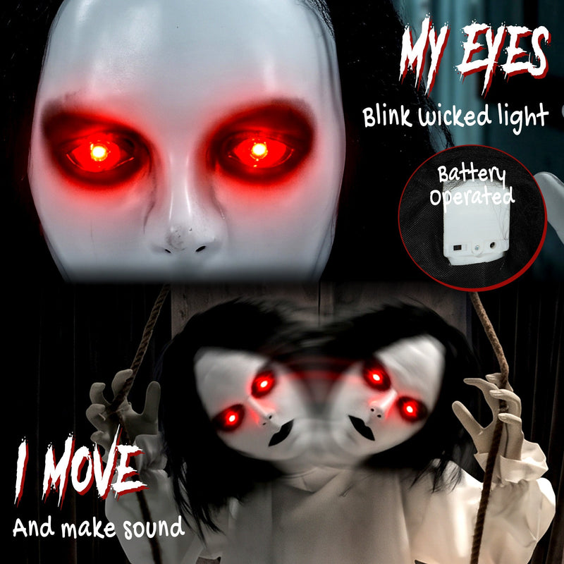 Close-up of the hanging swing ghost's glowing red eyes and battery pack