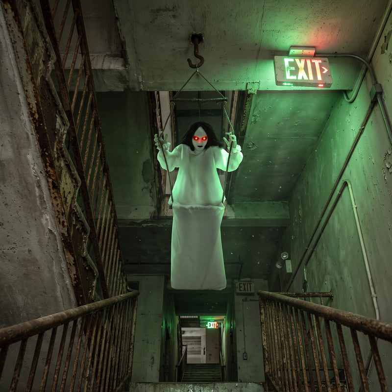Hanging swing ghost decoration suspended in a derelict stairwell display