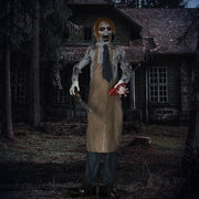 Zombie Halloween prop lit up at night outside a derelict house