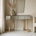 Antique mirror console table with two drawers styled in a bright hallway setting