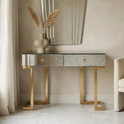 Antique mirror console table with two drawers styled in a bright hallway setting