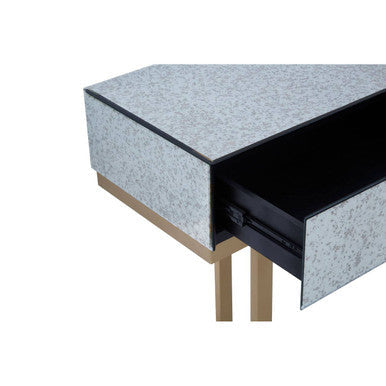 Close-up of a brass-finish square drawer pull against the silver mirror front