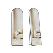 Arched floor mirror on its stand, shown face-on and angled, reflecting a white sofa with yellow cushions