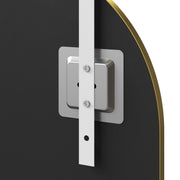 Close-up of a hook and mounting plate on the back of the arched mirror