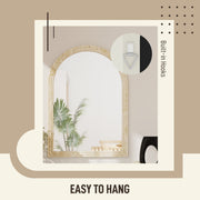 Close-up of the built-in wall mounting hooks on the back of the beige mirror