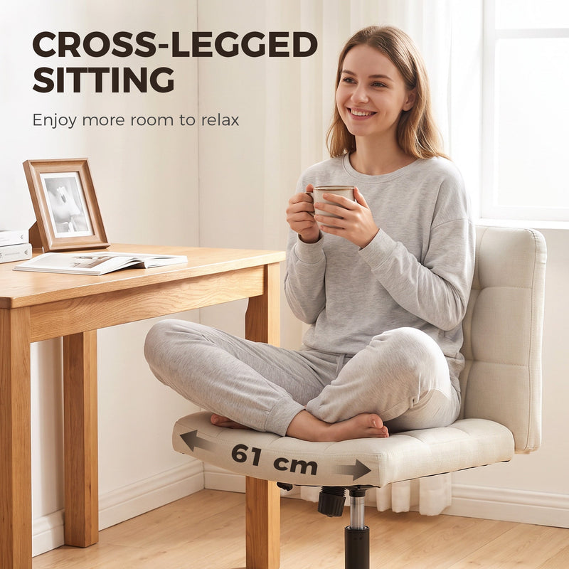 Woman sitting cross-legged on the beige Homcom office chair's 61 cm wide seat