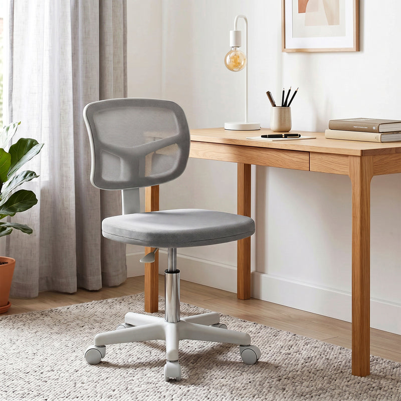 Armless mesh office chair in a home workspace setting