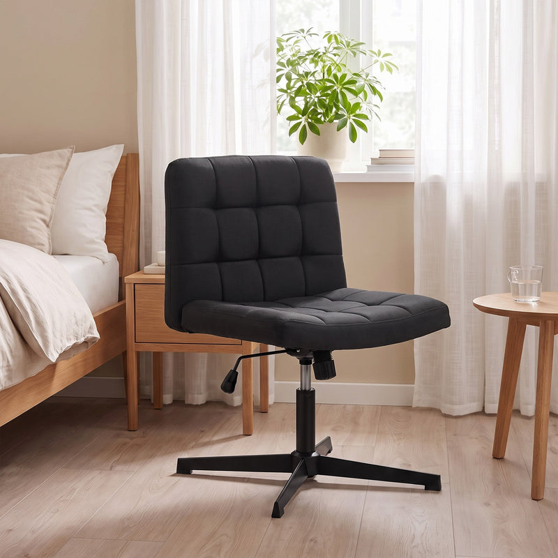 Black armless chair positioned under a vanity table