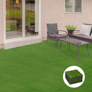Artificial grass tiles laid on a patio beside rattan garden furniture