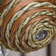 Artificial hanging flower pots shown on a patio setting