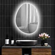 Asymmetric LED bathroom mirror, 80 x 60 cm: above a black basin on a dark tiled wall