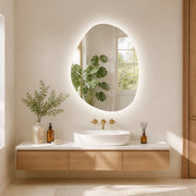 Asymmetric LED bathroom mirror, 70 x 50 cm: illuminated above a vessel basin in a bright bathroom