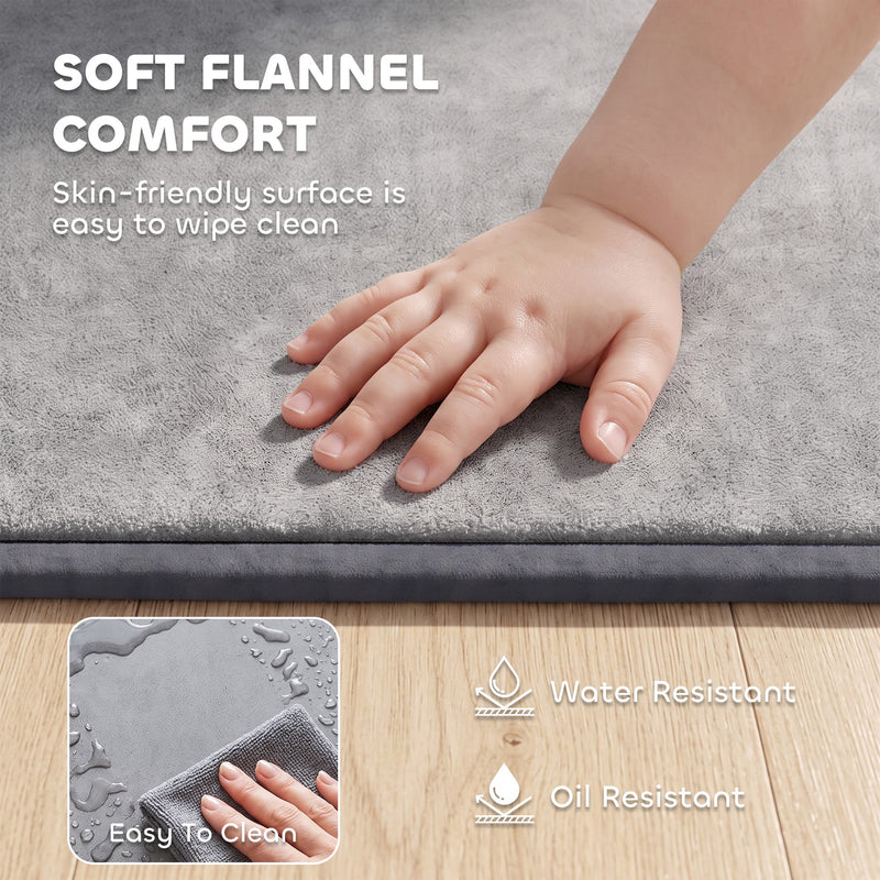 Baby's hand resting on the soft flannel surface of the play mat