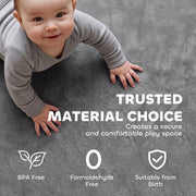 Baby crawling on the grey play mat with trusted material safety icons