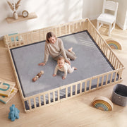Mother and baby sitting on the grey play mat inside a wooden play pen