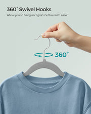 Hand rotating the hanger's swivel hook 360 degrees while it holds a blue jumper