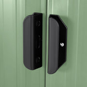 Close-up of the black door handles set against the light green sliding doors of the metal shed