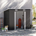 Black Outsunny 7x4ft metal garden shed beside a house wall with its sliding doors open, tools and a gas bottle stored inside