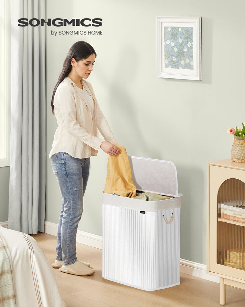 White bamboo laundry basket with lid open showing 2 compartments
