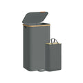 Slate grey laundry hamper with bamboo rim shown beside its removable liner