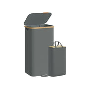 Slate grey laundry hamper with bamboo rim shown beside its removable liner