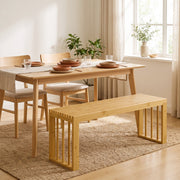 Bamboo bench used as a dining bench beside a wooden dining table
