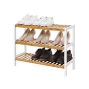 Bamboo shoe rack holding trainers, heels and boots across its three shelves