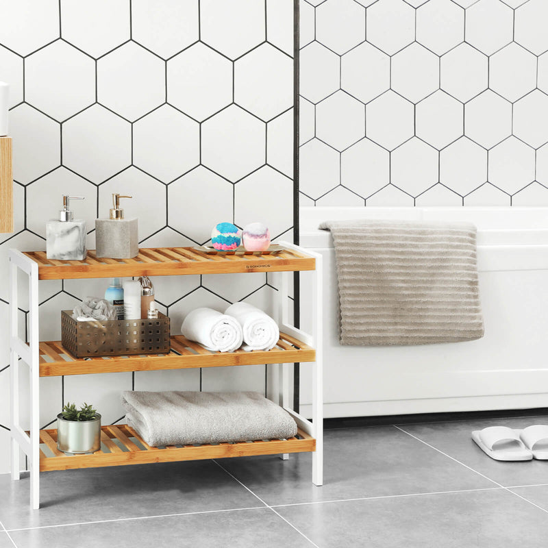 Bamboo shoe rack used in a bathroom to store rolled towels and toiletries