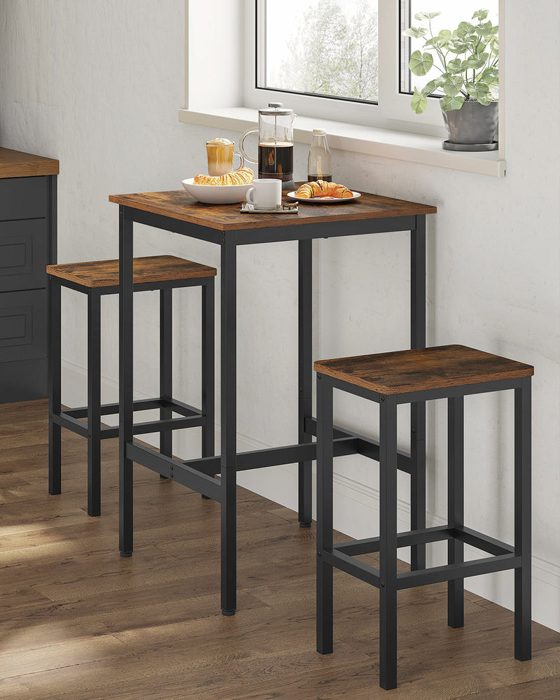Bar table with two matching stools set for breakfast beside a kitchen window