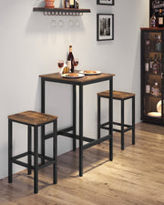 Bar table and two stools laid with wine and plates in a home bar corner